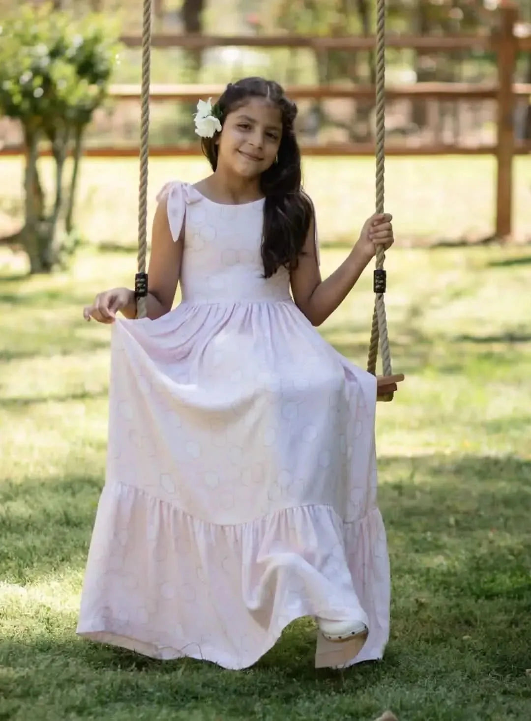 Peach fabric with geometric hexagon print in soft, peachy tones.