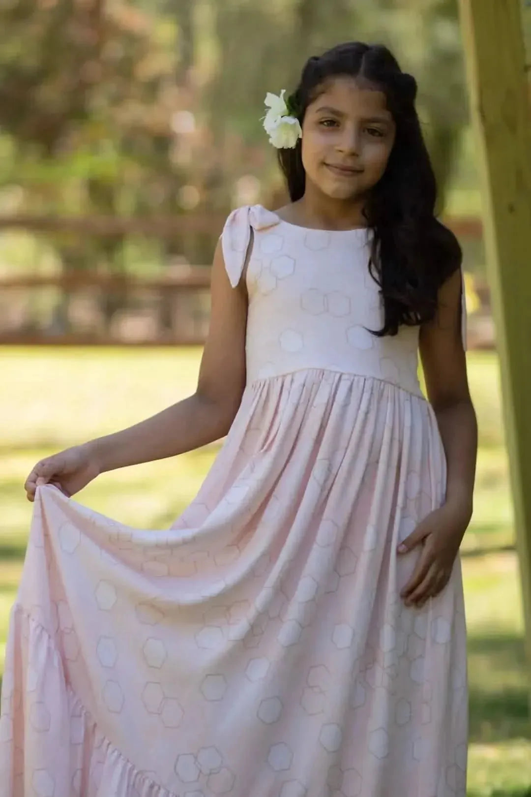 Peach fabric with geometric hexagon print in soft pink tones.