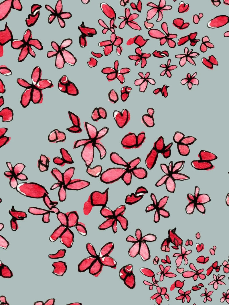 Fabric with a pattern of scattered red and pink watercolor flowers on a gray background.
