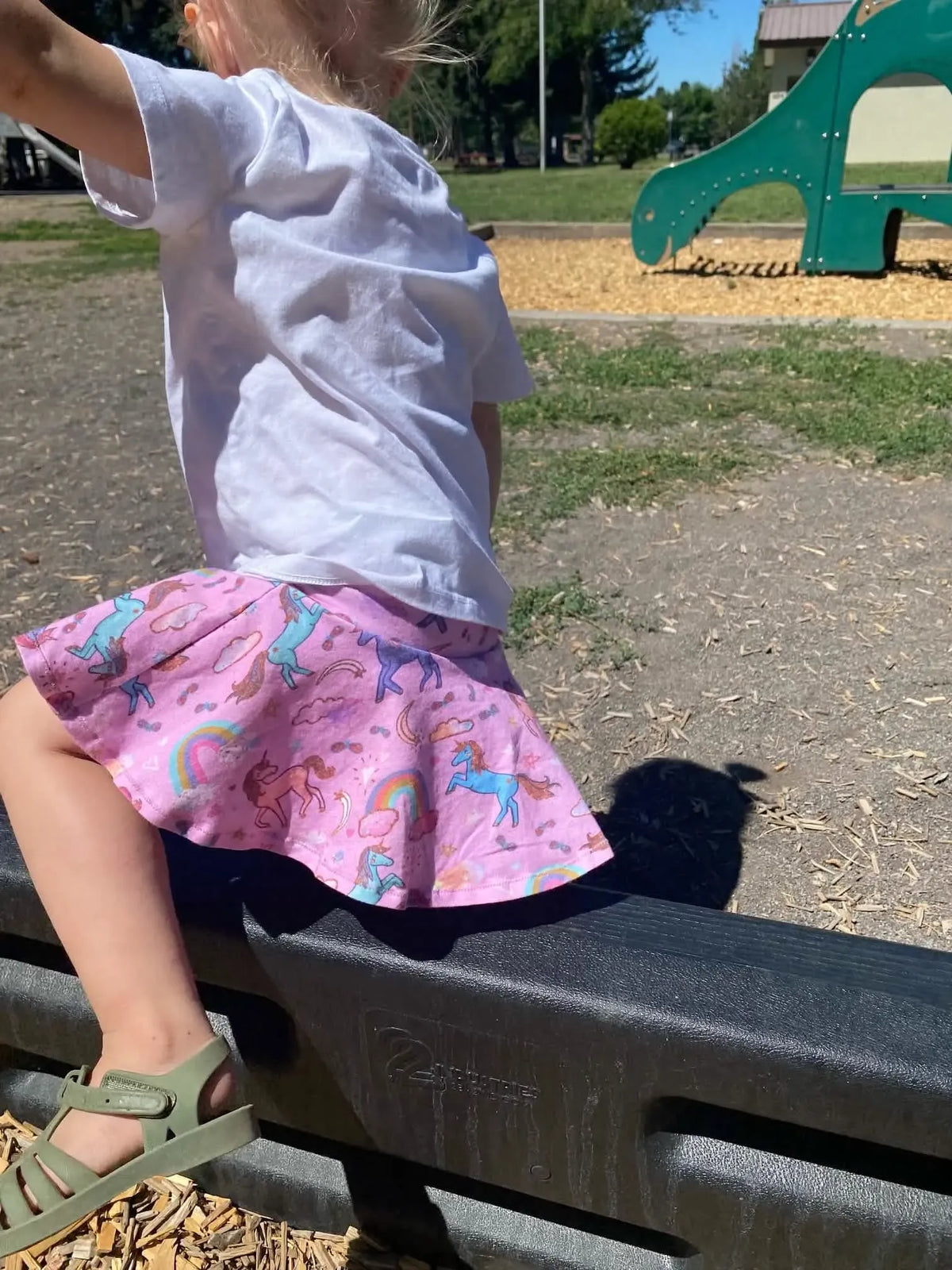Pink unicorn sparkle fabric on a child's skirt.
