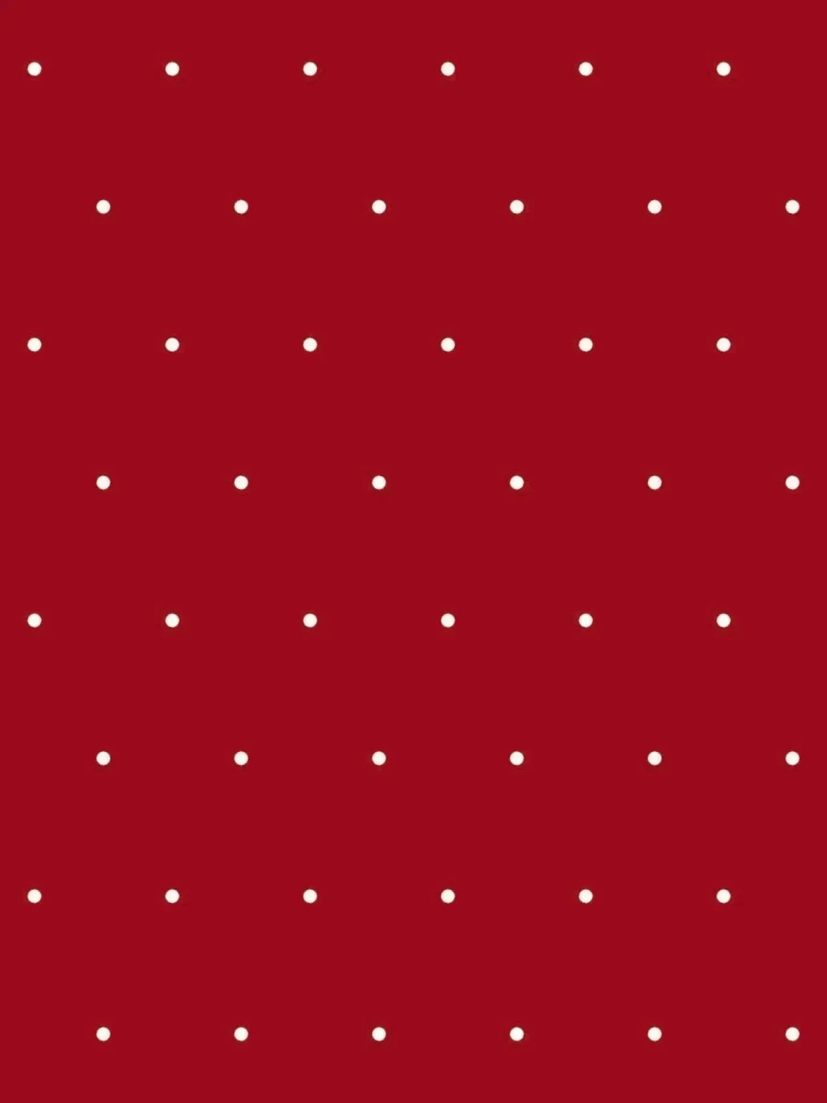 Red polka dot print fabric with white dots on a solid red background.