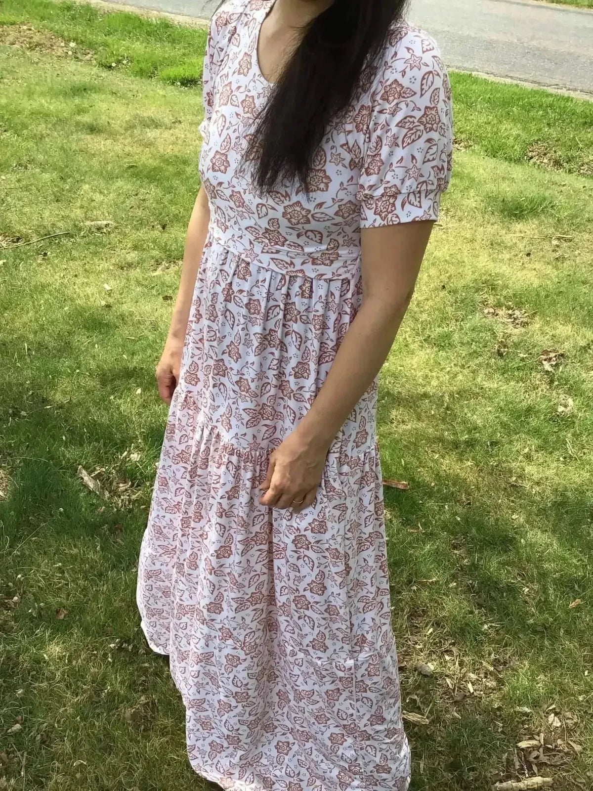 White floral print fabric with folk flower pattern on light background.