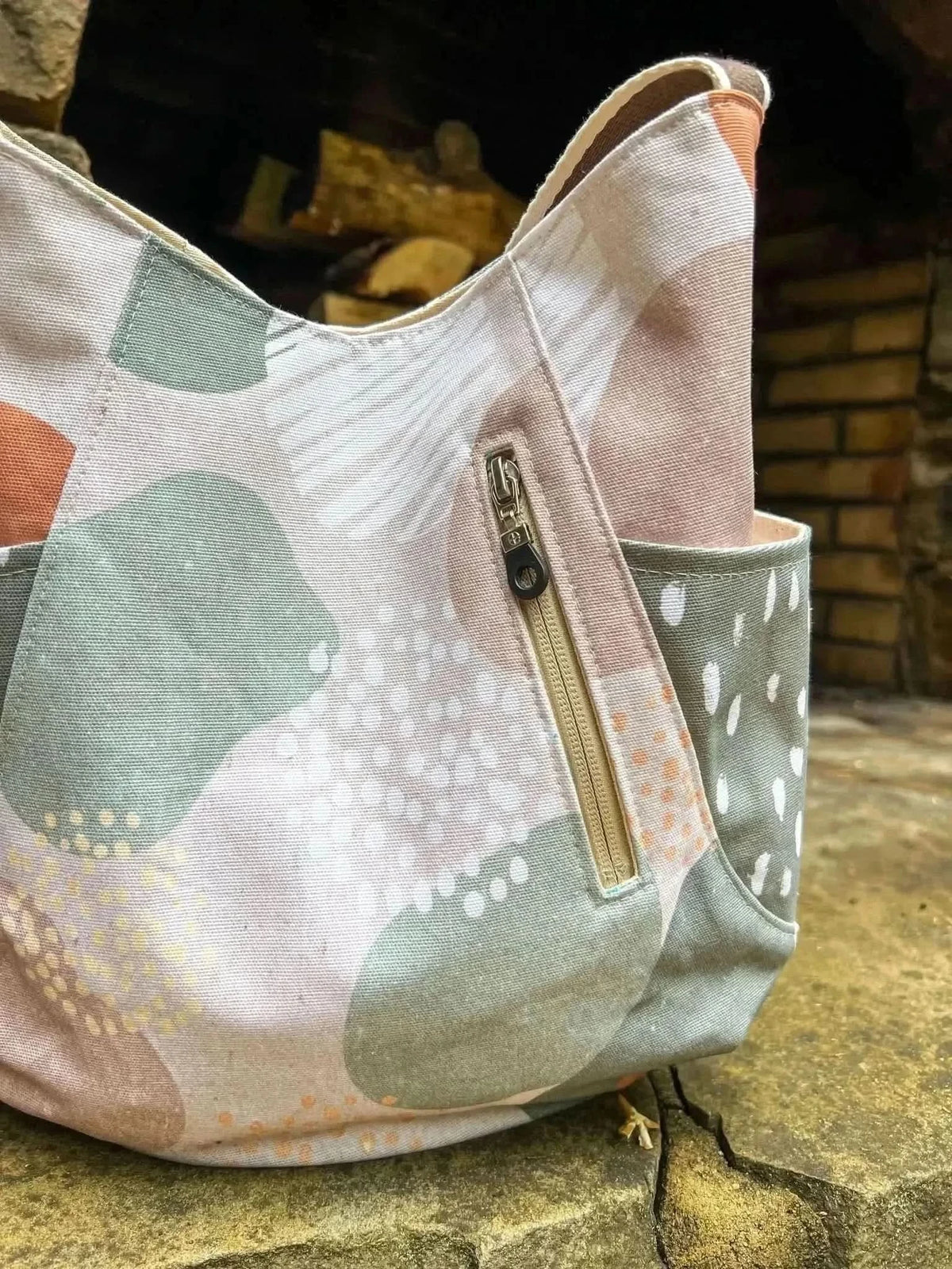 Mod Forest Fabric with earthy forest theme print in green, beige, and orange tones.