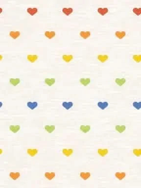 A white fabric with rows of small, colorful hearts in a rainbow pattern.