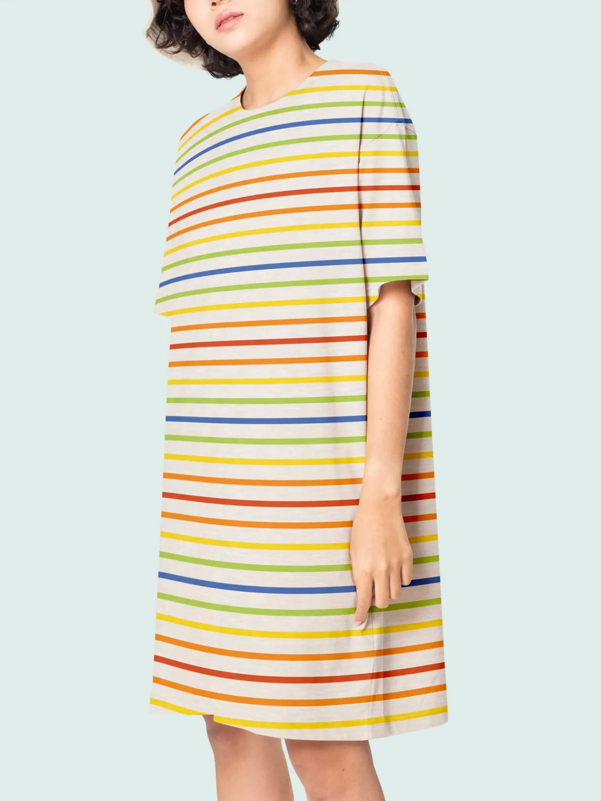 A person models a cream dress with colorful horizontal stripes.