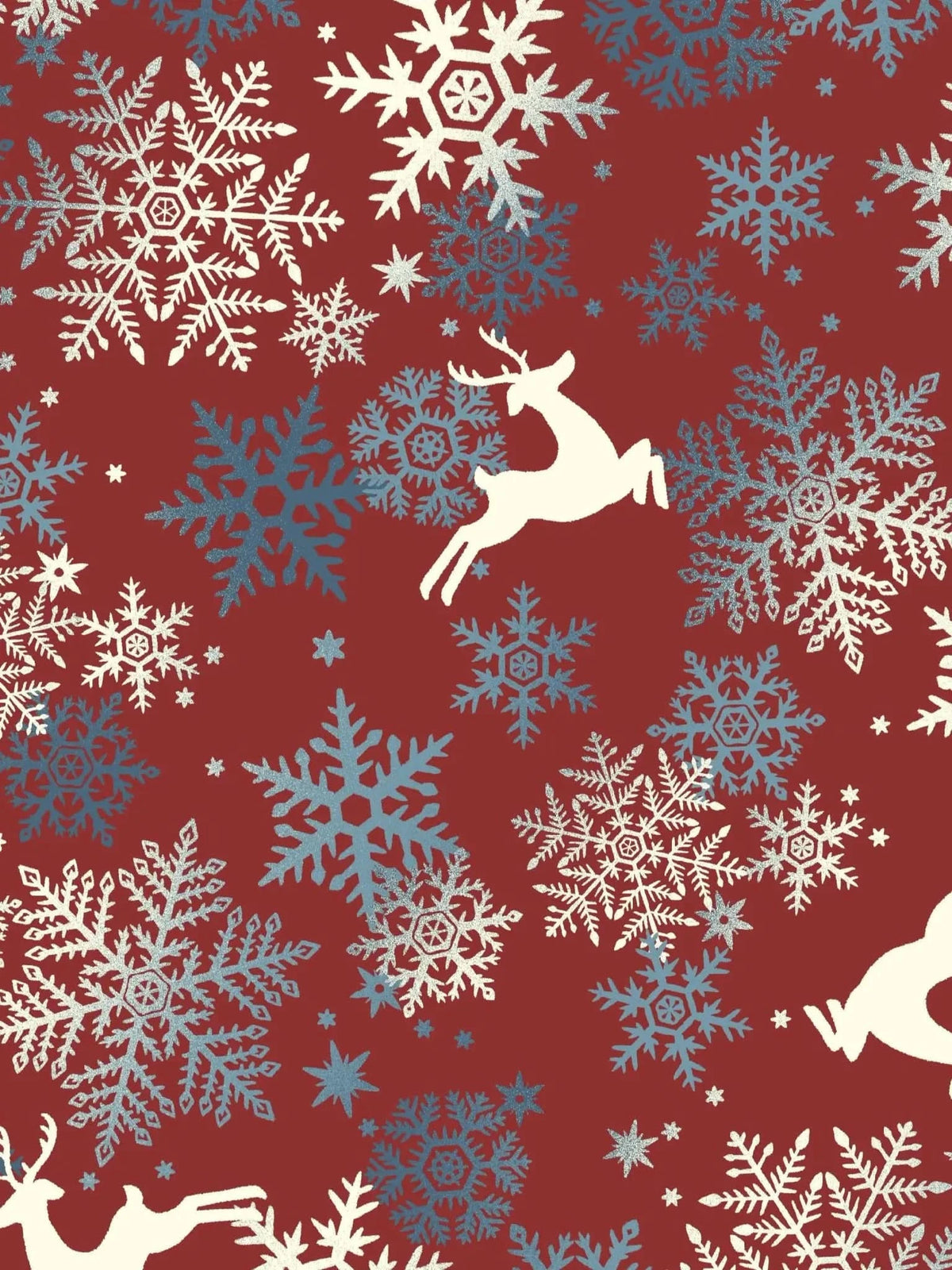 A red fabric with white and blue snowflakes and white reindeer.