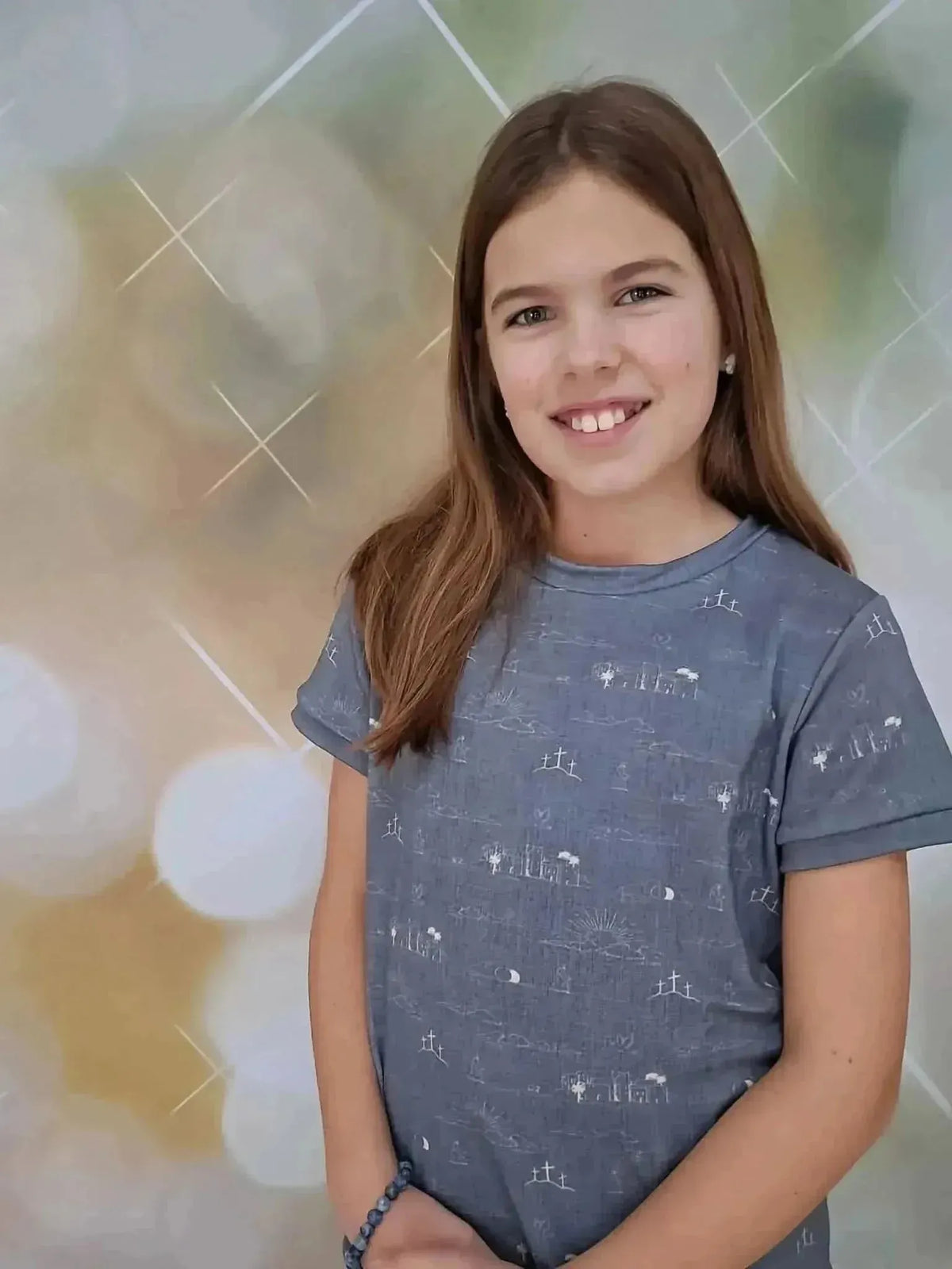 Girl wearing a sky blue Resurrection Story faith print t-shirt with subtle patterns.