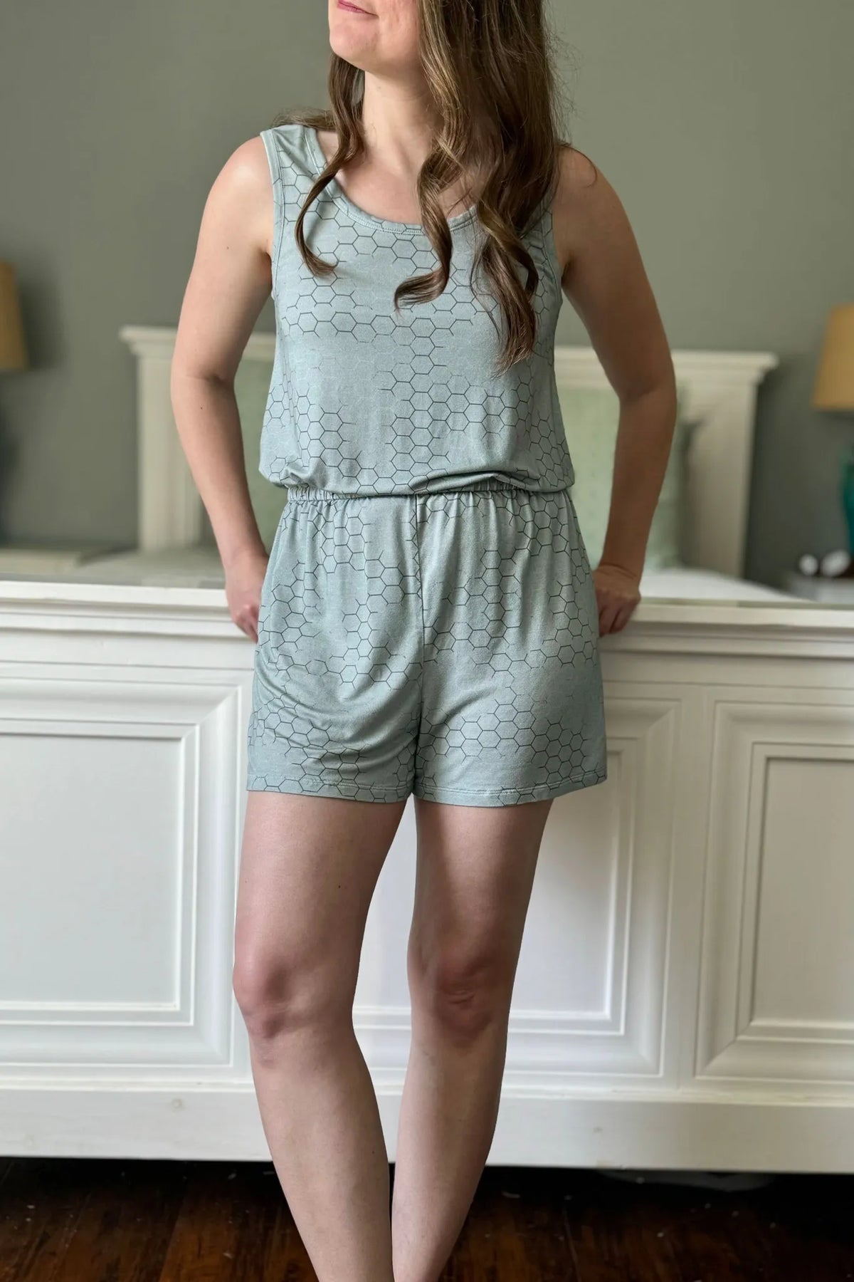 A woman models a light green honeycomb-patterned tank top and shorts set.