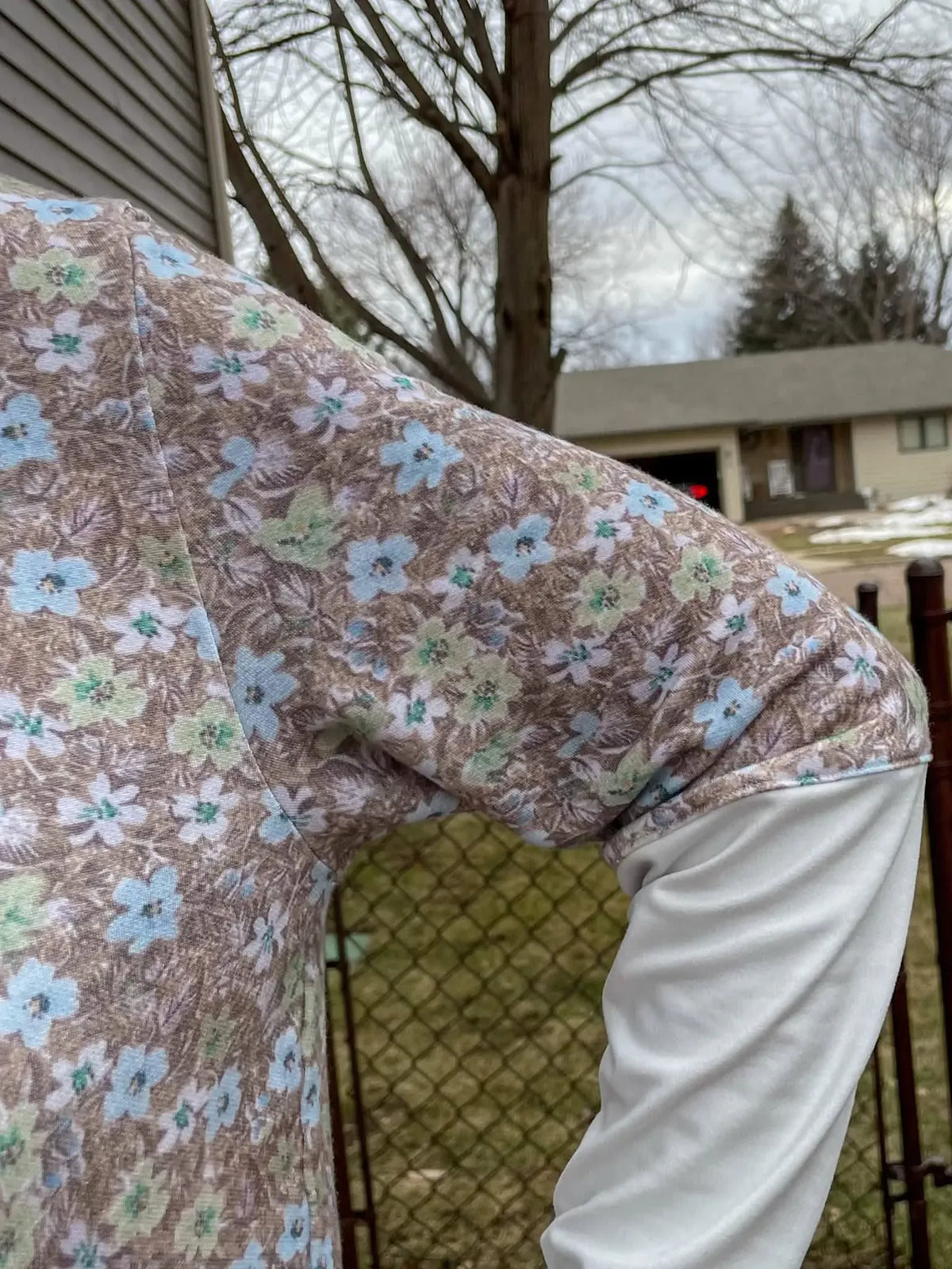 Brown fabric with light blue and green floral pattern.