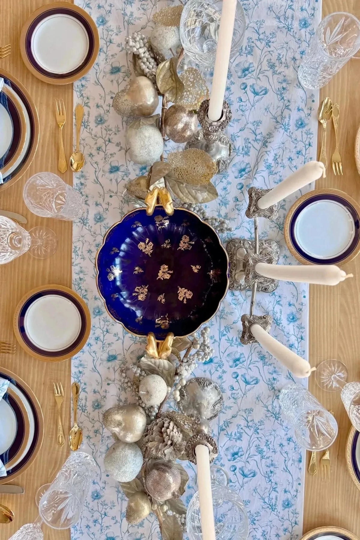 Blue botanical print fabric with garden symphony pattern on a white background.