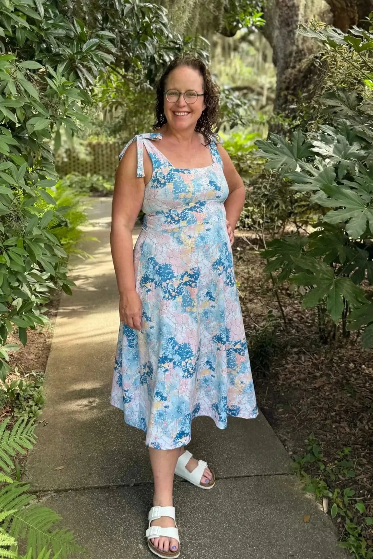 Blue and pink abstract floral fabric with faith-based print, shown as a sleeveless sundress.