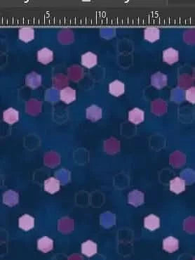 Blue fabric with scattered pink, purple, and blue hexagons and faint geometric outlines.
