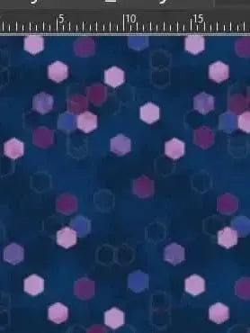 Blue geometric hexagon print fabric with pink and purple hexagons on a navy background.