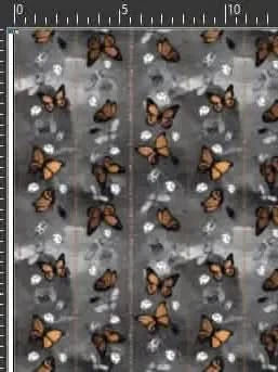 A fabric with a repeating pattern of orange monarch butterflies on a gray and white background.