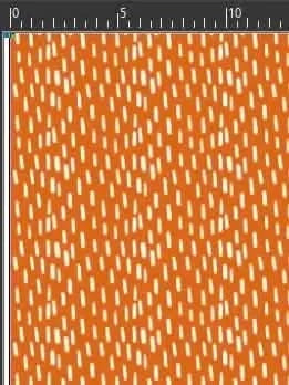 An orange fabric with a pattern of small, scattered white dashes.