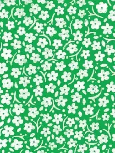 Green fabric with a repeating pattern of small white flowers and leaves.