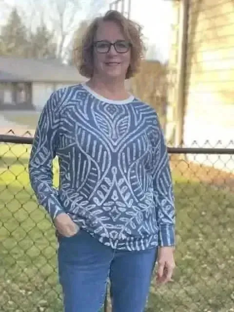 Blue geometric Art Deco flapper print fabric with intricate white patterns.