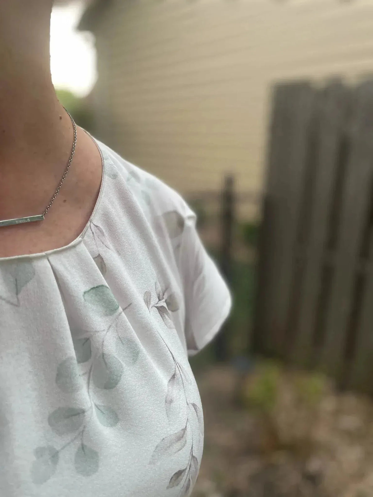 Close-up of white fabric with green eucalyptus leaves botanical print.