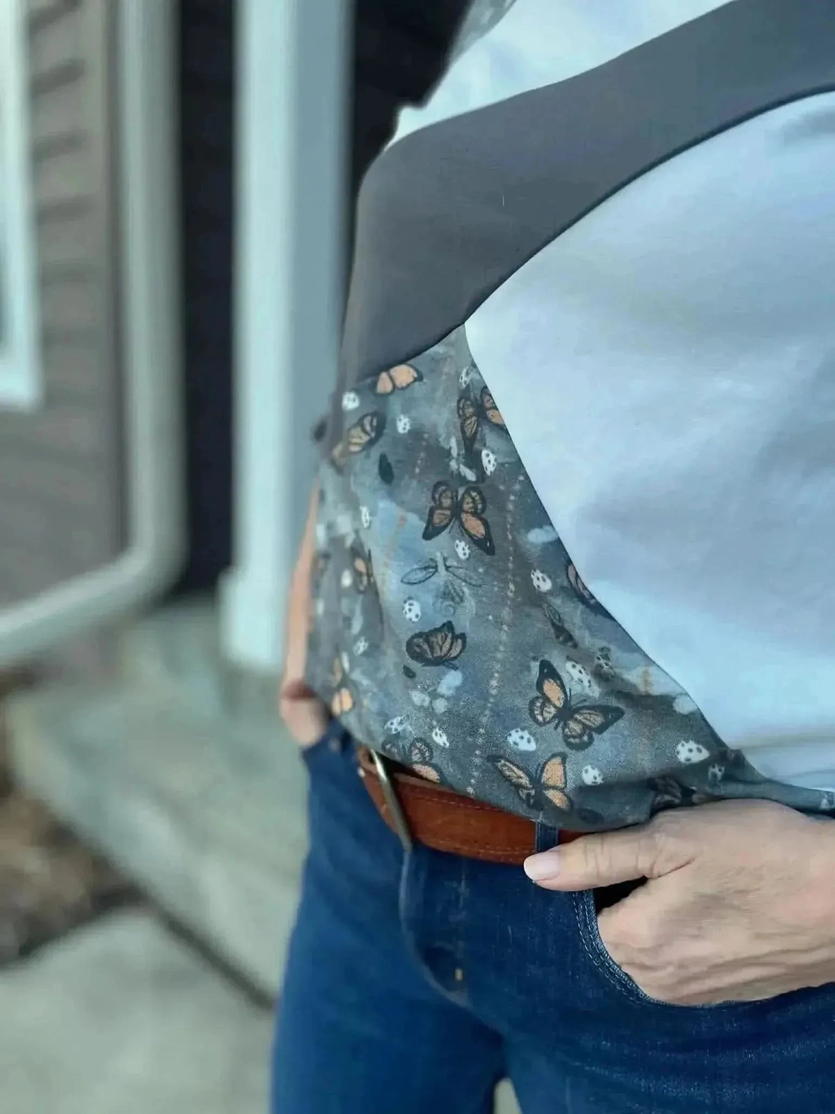 Gray fabric with a subtle monarch butterfly print pattern.