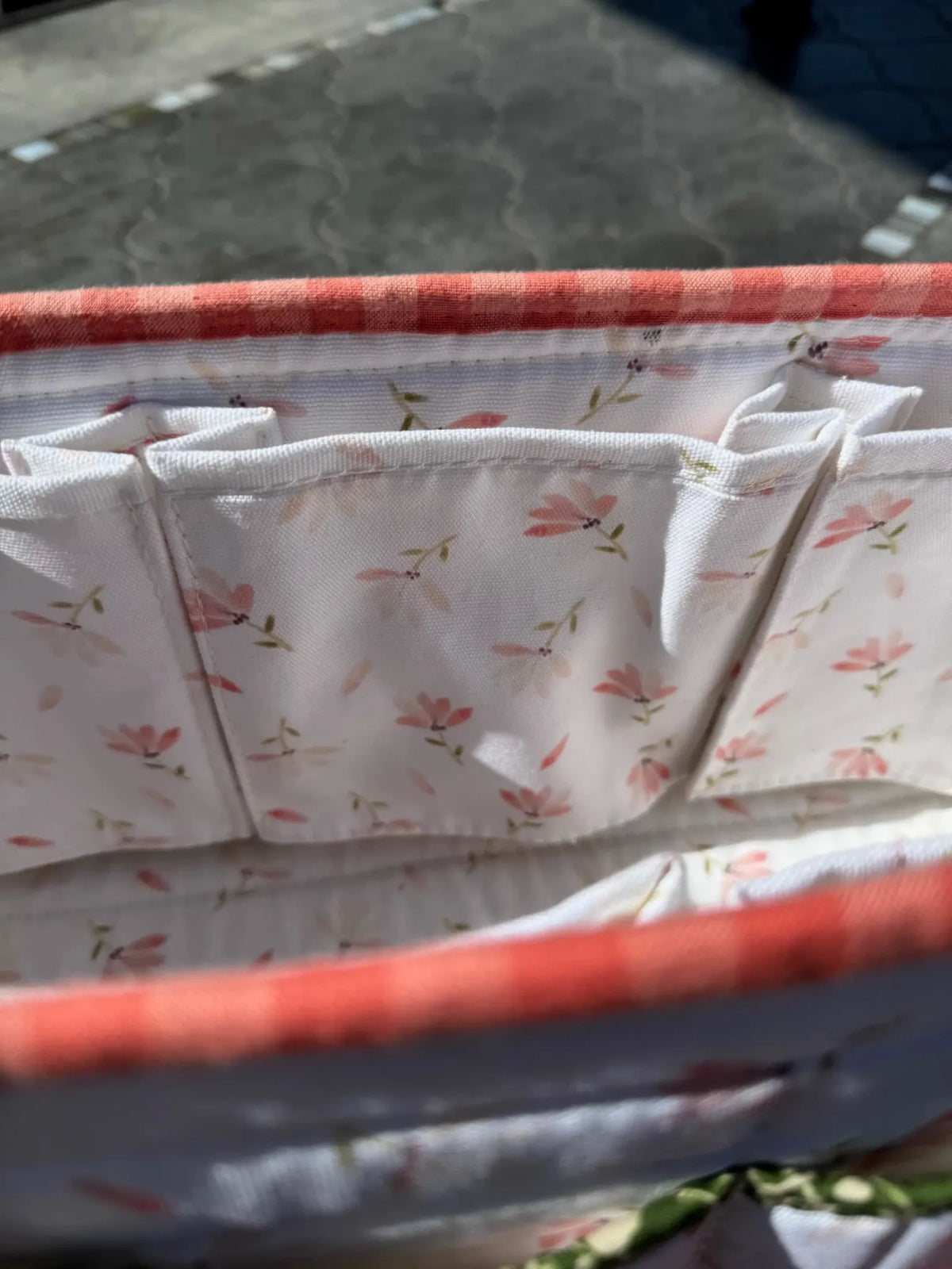 Fabric with a spring flowers pattern and red gingham trim.