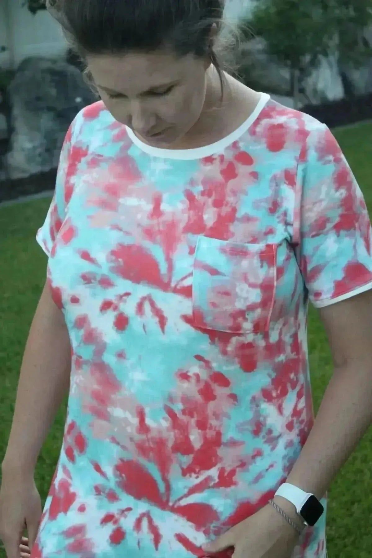 Pink and aqua tie-dye fabric with swirling patterns in a summer style.