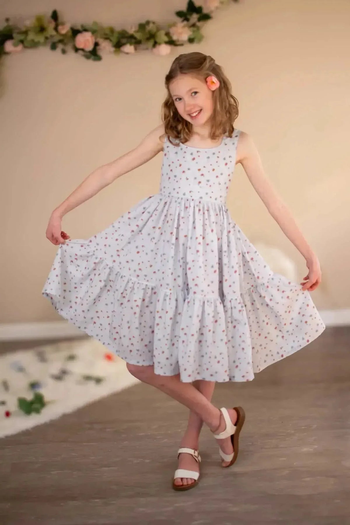 Light blue floral fabric with garden print, shown in a tiered girl's dress.