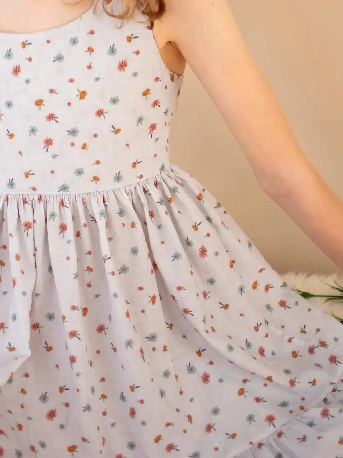 Light blue fabric with a subtle floral garden print in soft colors.