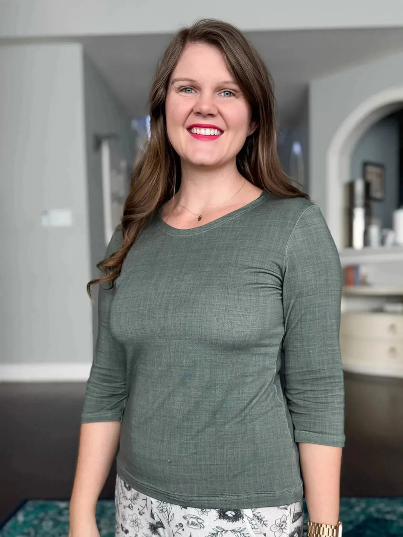 Olive linen fabric swatch in neutral tone, shown as a woman's long-sleeve top.