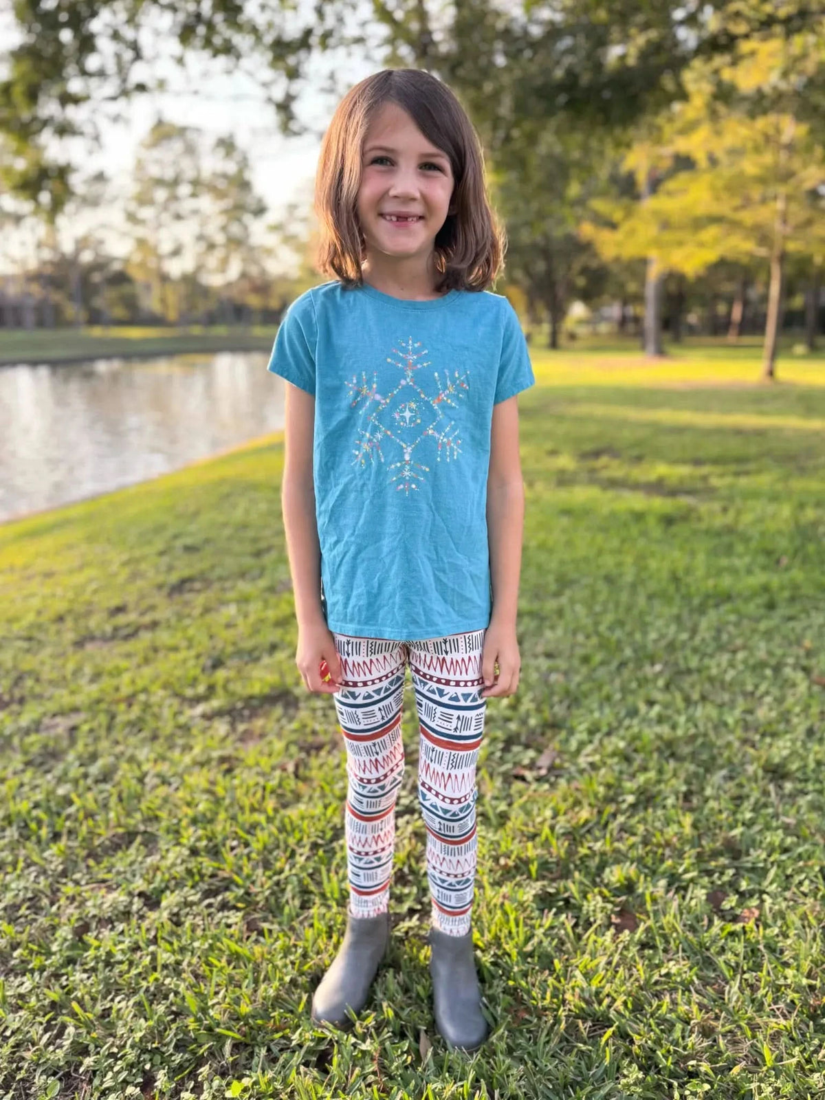 A young girl wears leggings with a desert-inspired pattern.