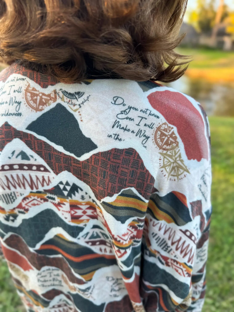 A person wearing a "Make a Way" patterned fabric shirt from behind.