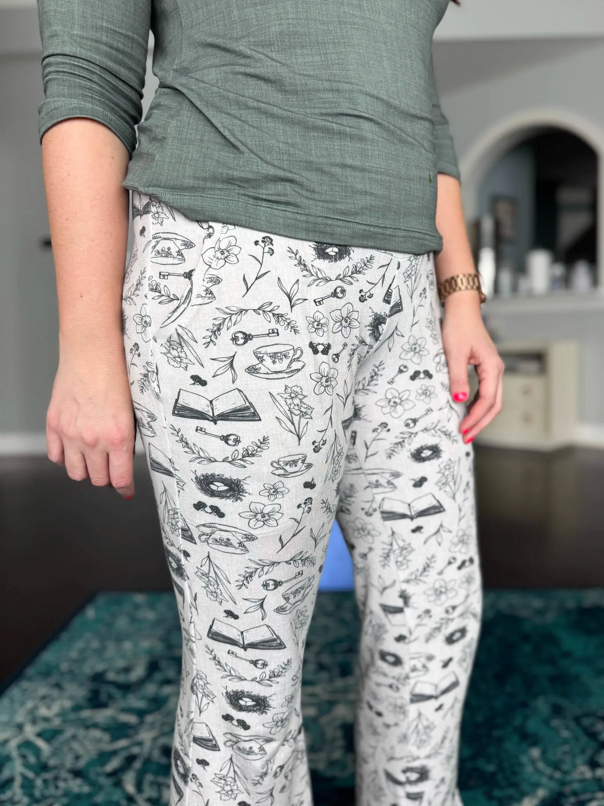 A person wears pants with a charcoal tea and toile pattern.