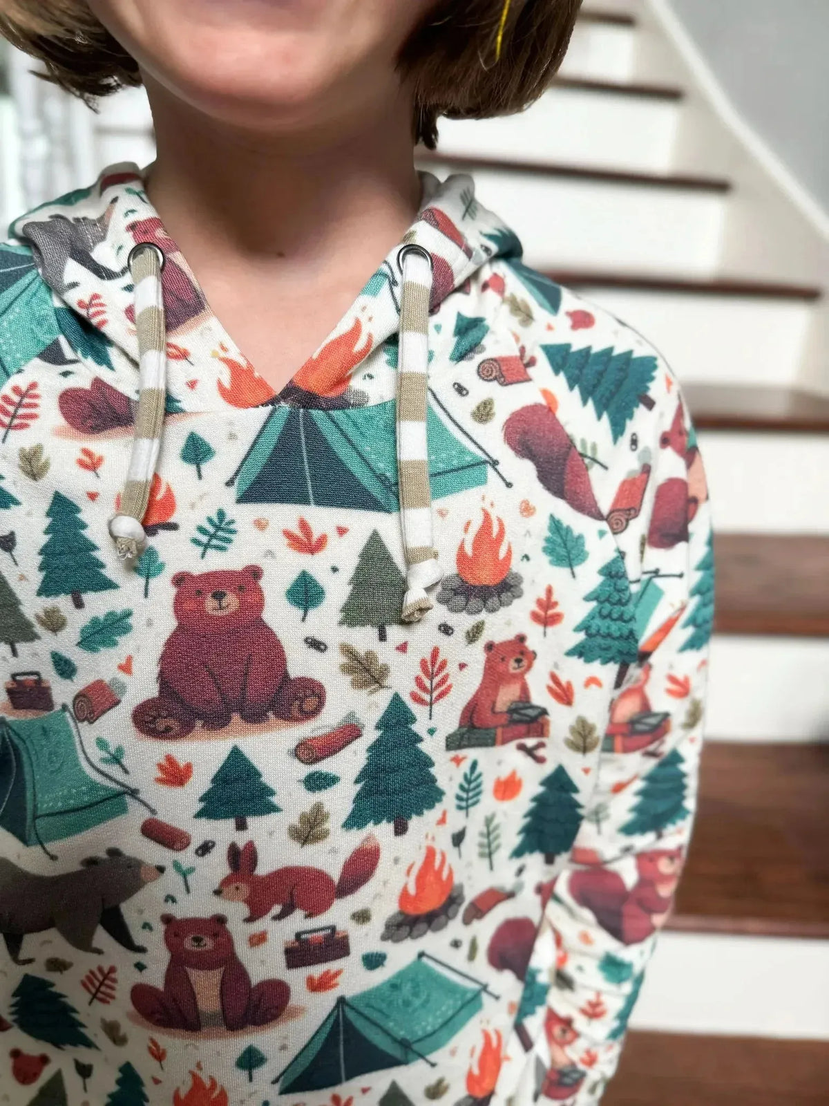 Camping bears print fabric with woodland animals, tents, trees, and campfire motifs.