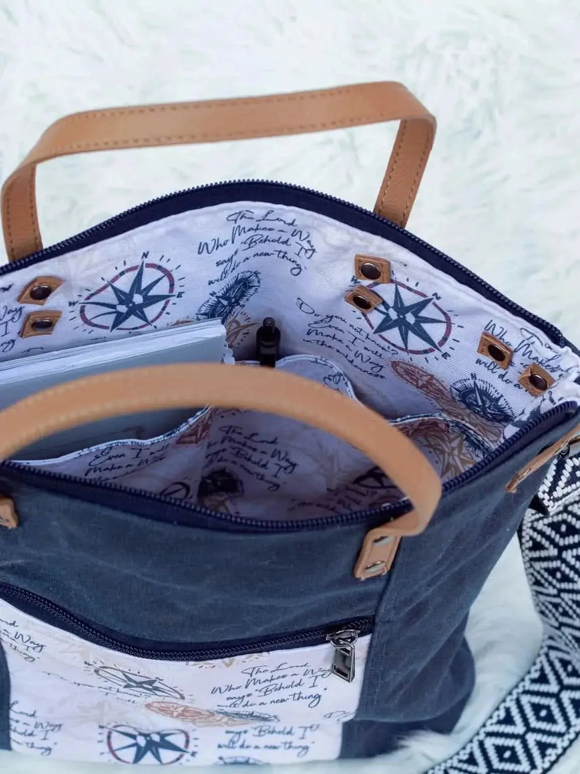 Blue-brown compass print fabric with nautical motifs on white background.