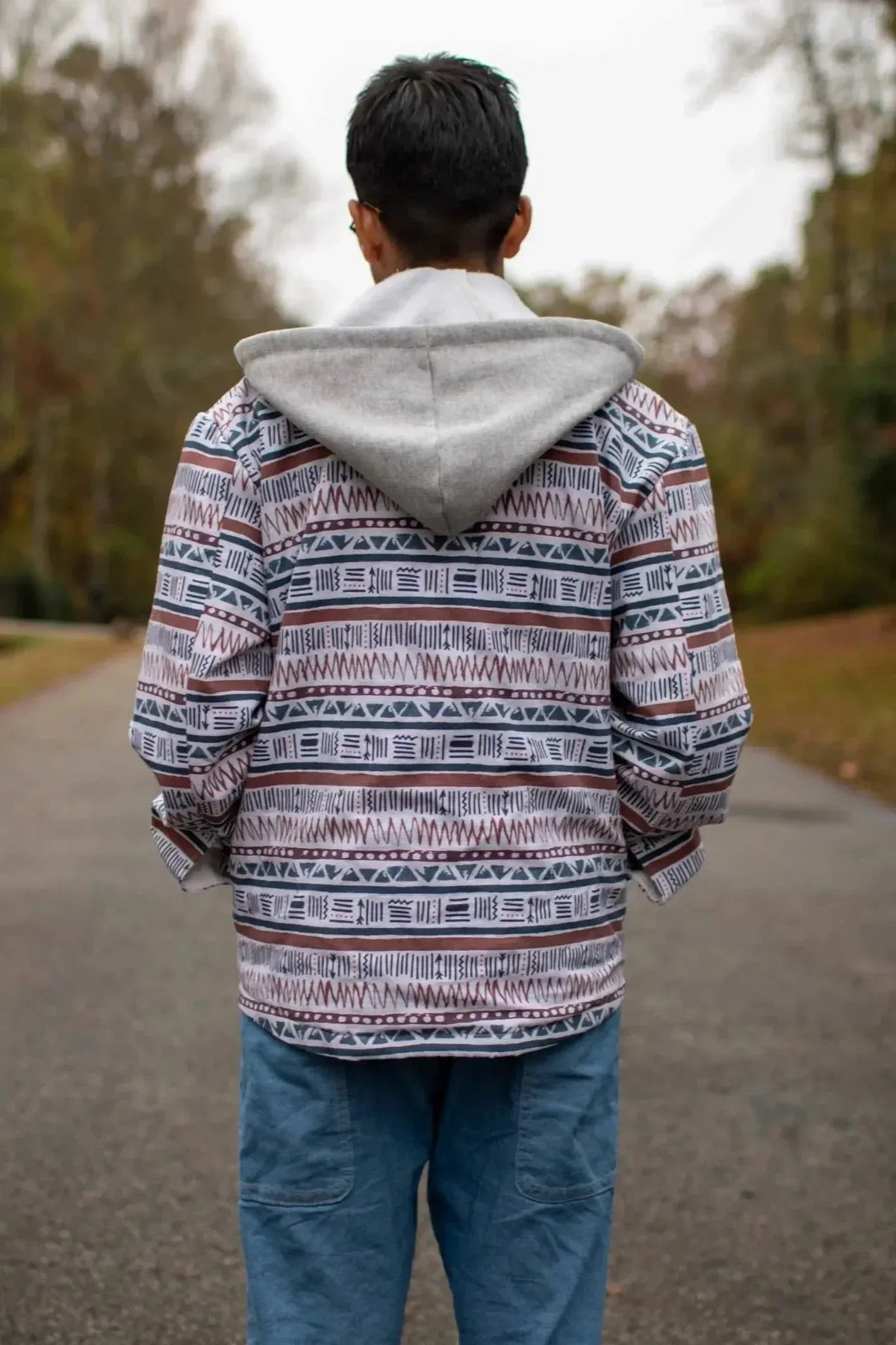 Back view of a hooded shirt made from Desert Echoes Faith-Based Fabric, showing striped pattern.