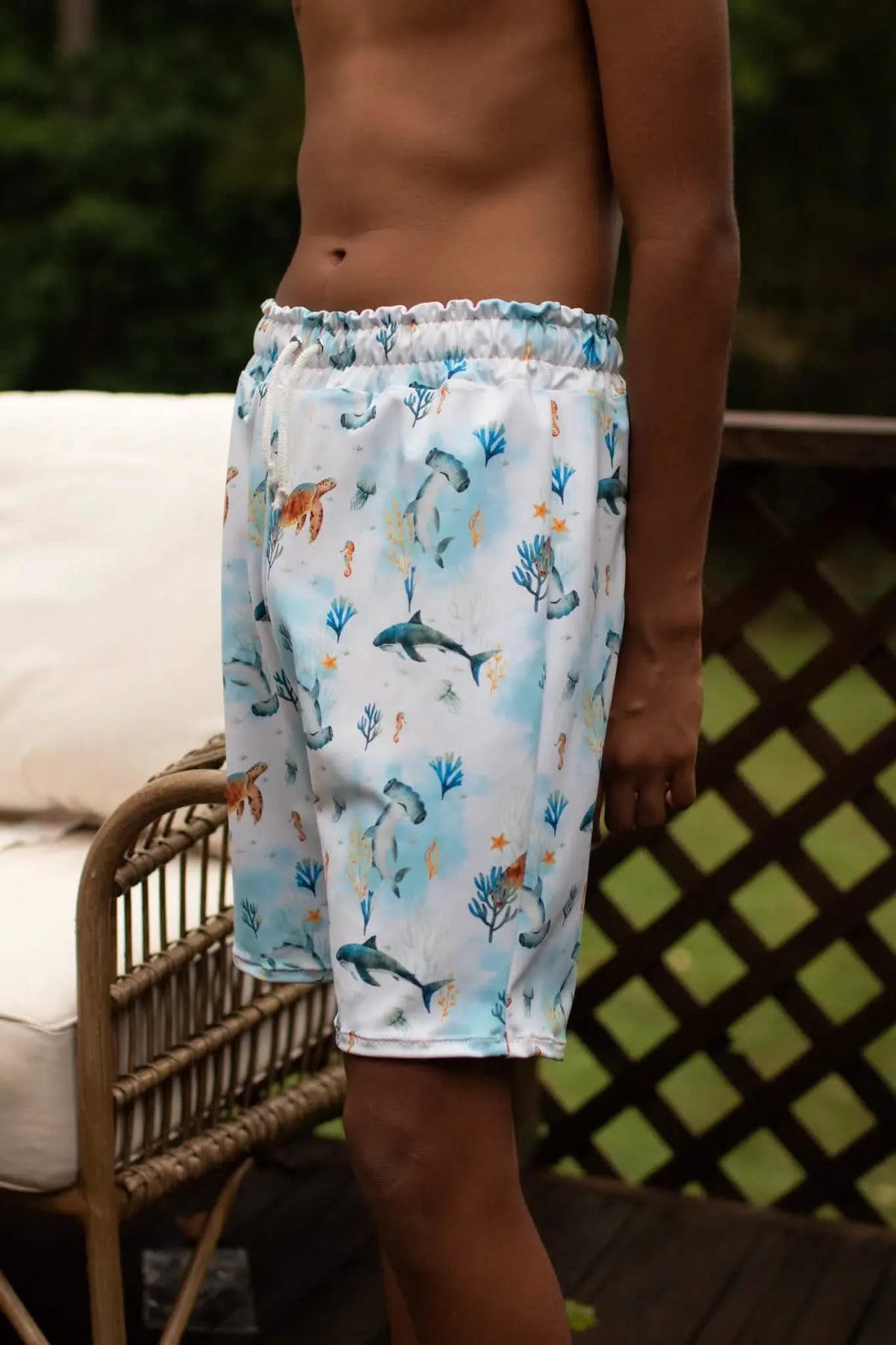 Under The Sea Blue swim shorts with marine life pattern.