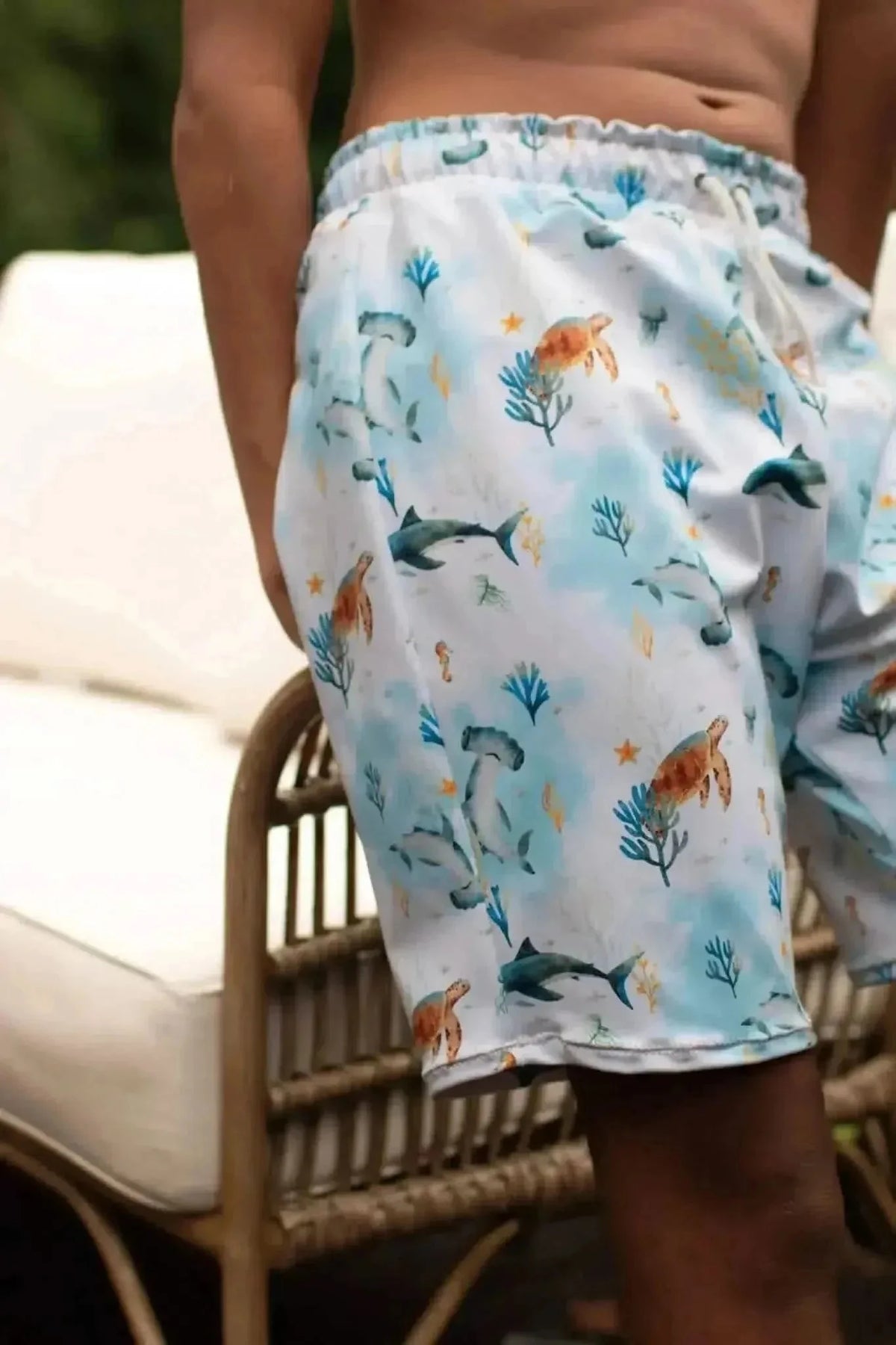 Blue aquatic print fabric featuring sea creatures like fish and coral on a light background.