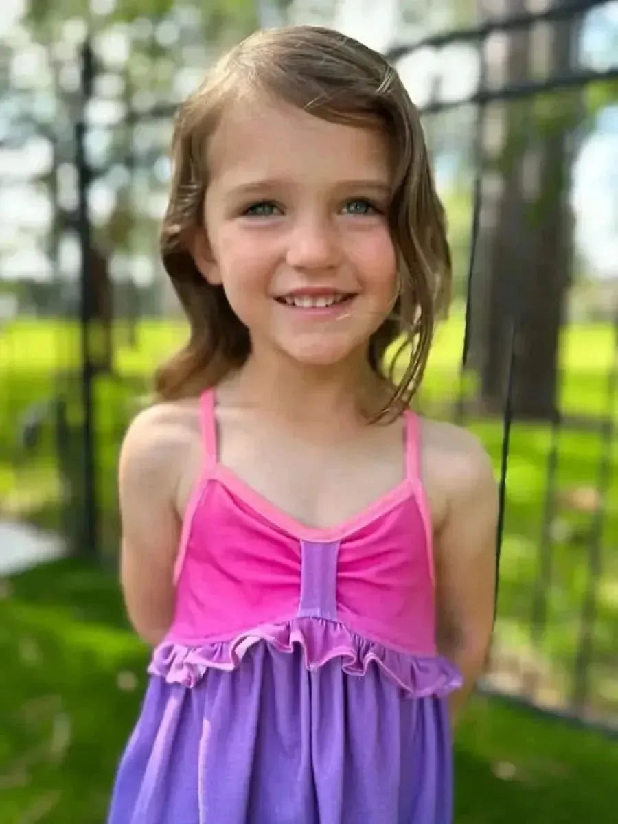 Purple-pink gradient ombre fabric with sunset print, shown in a sewn dress.