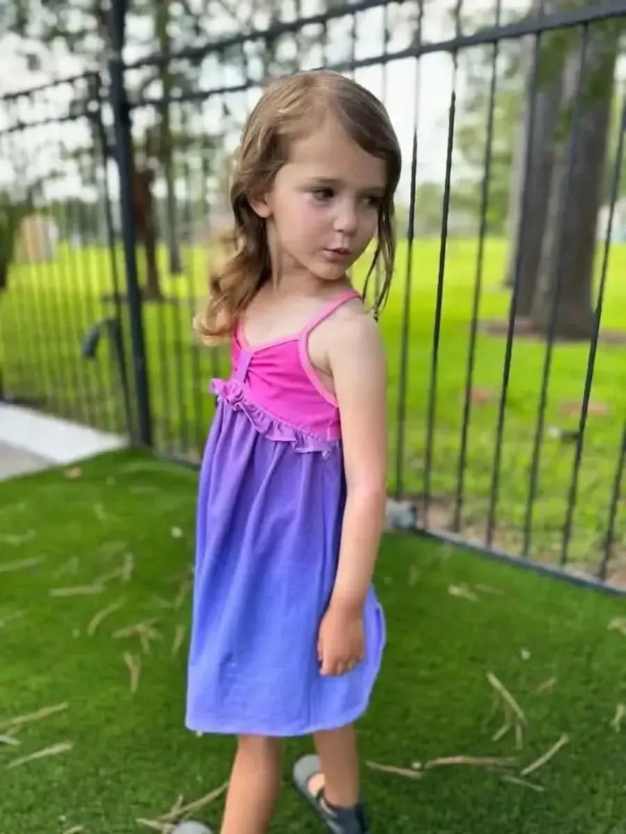 Purple pink gradient ombre fabric with sunset print, shown in a sewn dress.