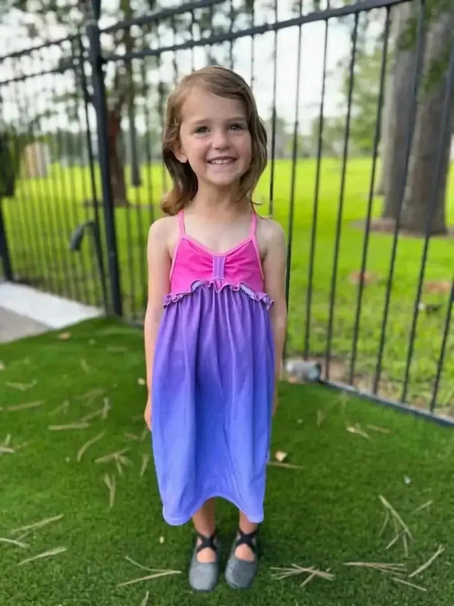 Purple-pink gradient ombre fabric with sunset effect, shown as a girl's sleeveless dress.