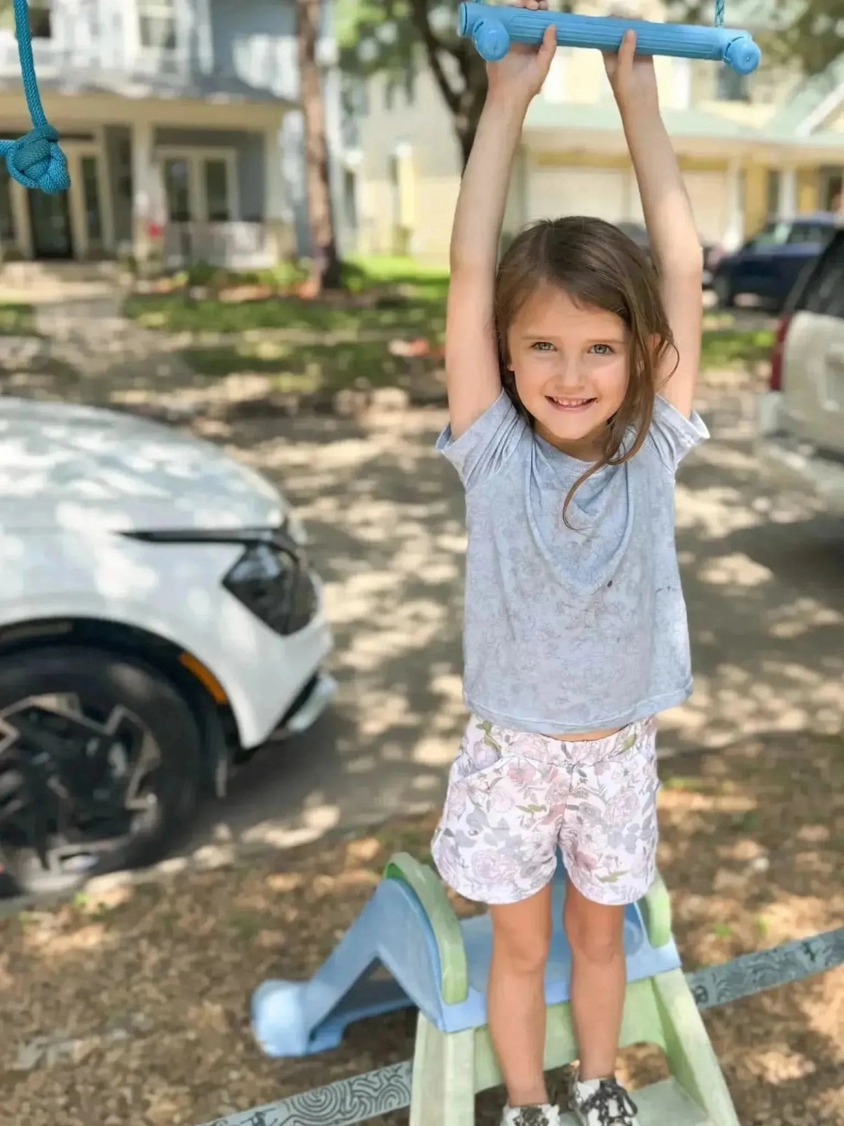 Dusty blue fabric with stenciled floral pattern in a close-up view.