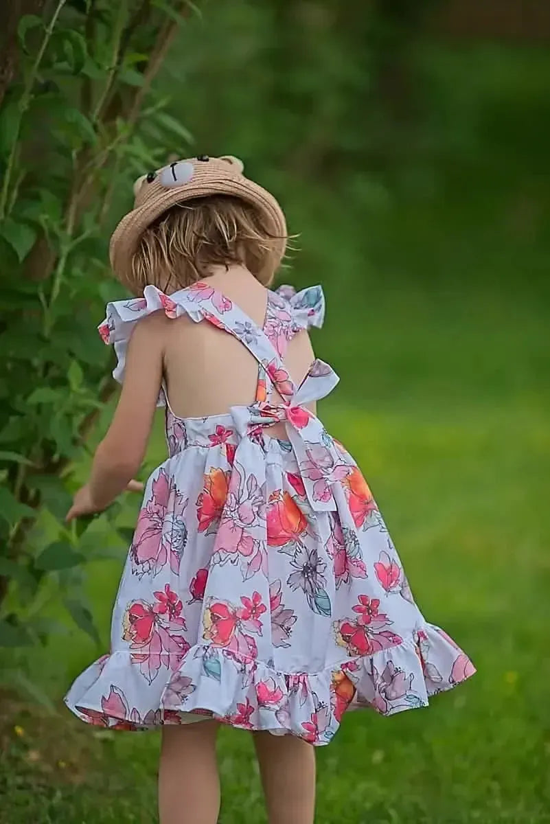 Floral print fabric with tossed memories pattern in pink and white tones.