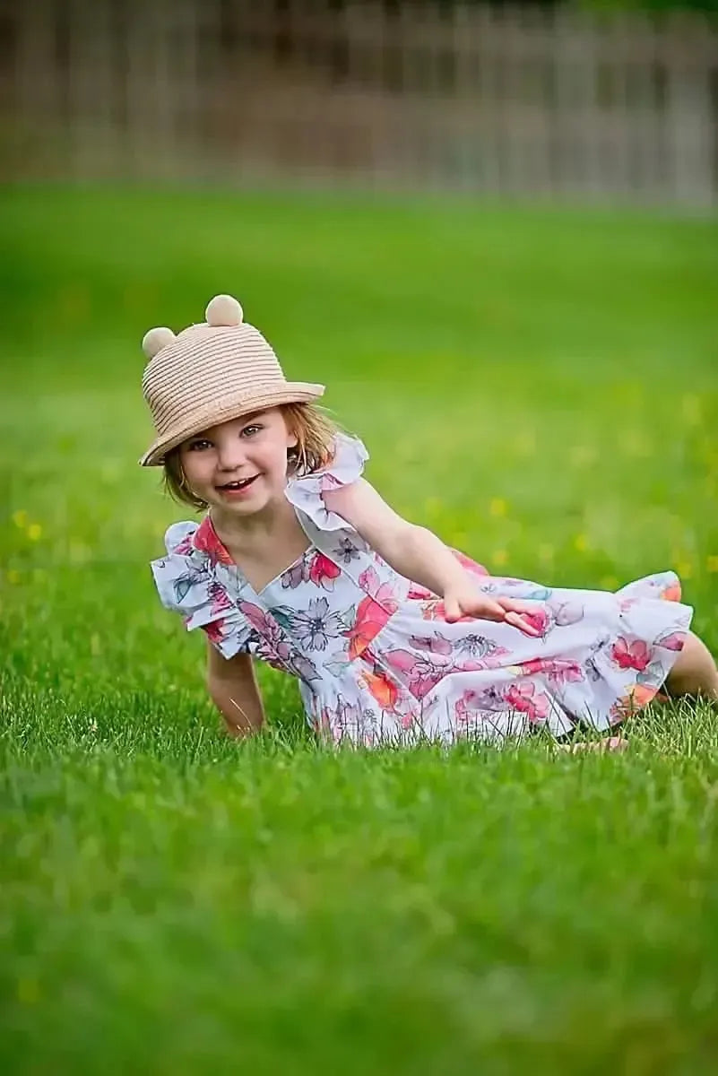 Floral print fabric with tossed memories pattern in pink and white tones.