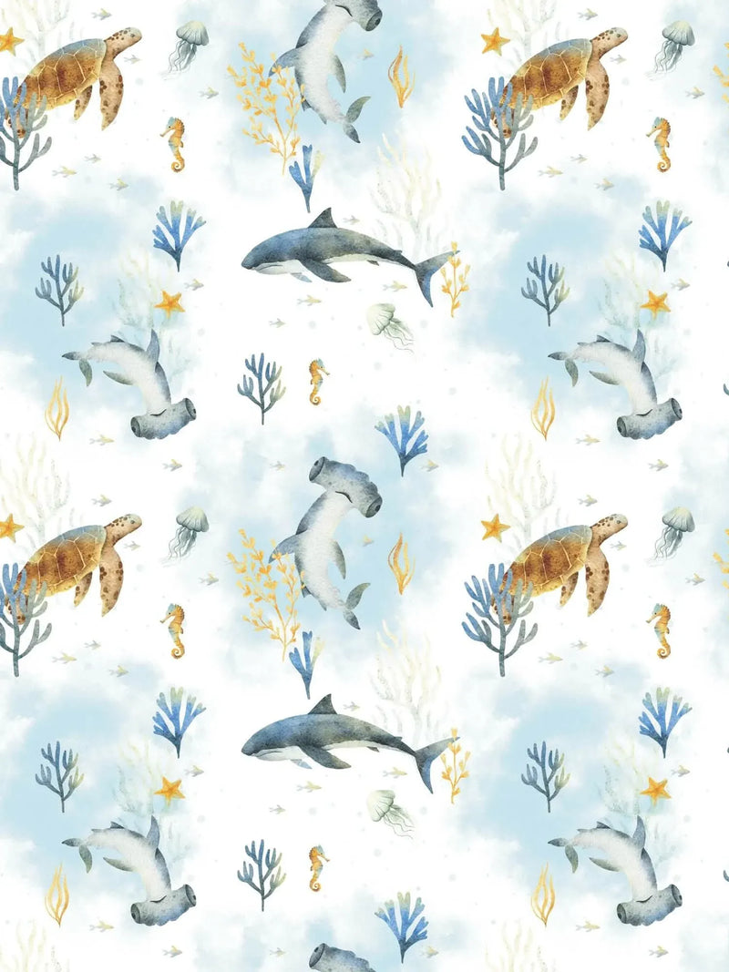Fabric with an underwater pattern featuring sharks, turtles, jellyfish, and coral on a blue background.