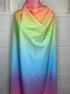 Rainbow gradient fabric draped to show the full color spectrum.