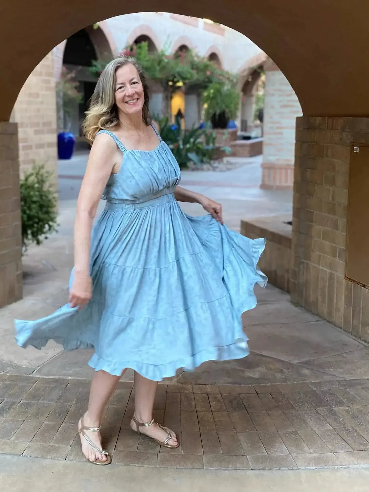 Dusty blue stenciled floral fabric in a tiered dress.