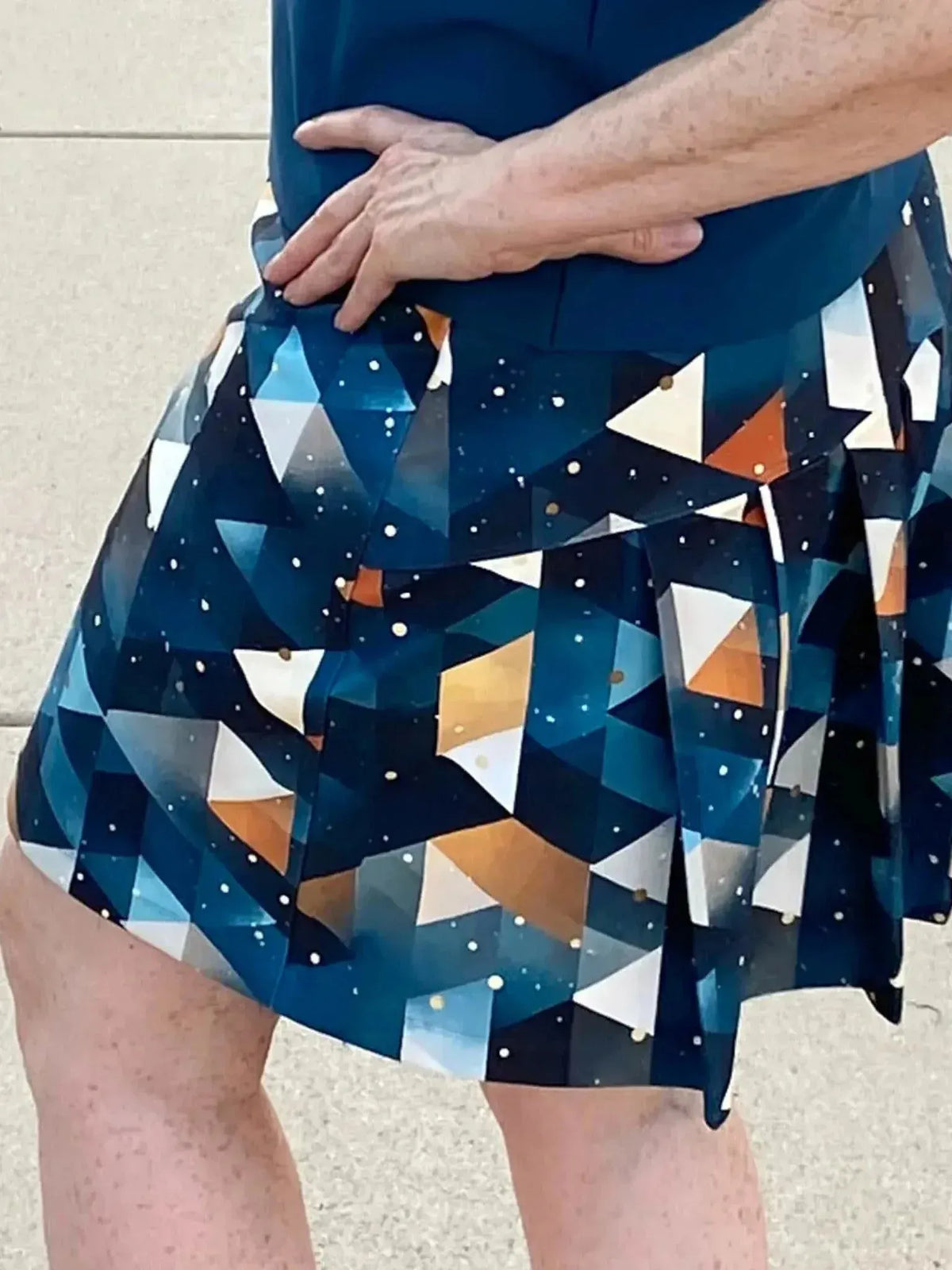 Blue and gold abstract celestial fabric with geometric triangles and star patterns.
