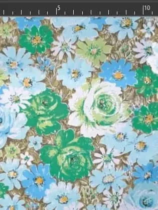 Floral print fabric with blue, green, and white flowers on a brown background.