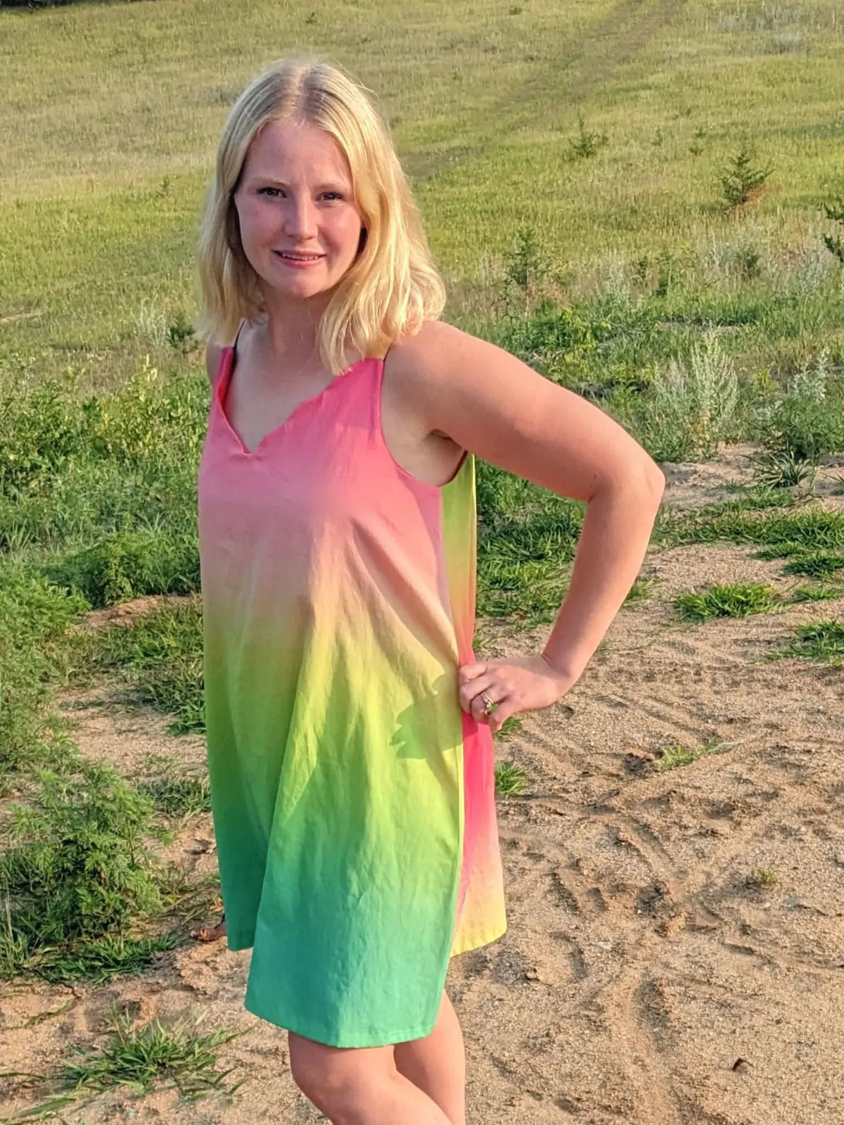 Watermelon ombre gradient fabric with pink-to-green hues on a grassy field.