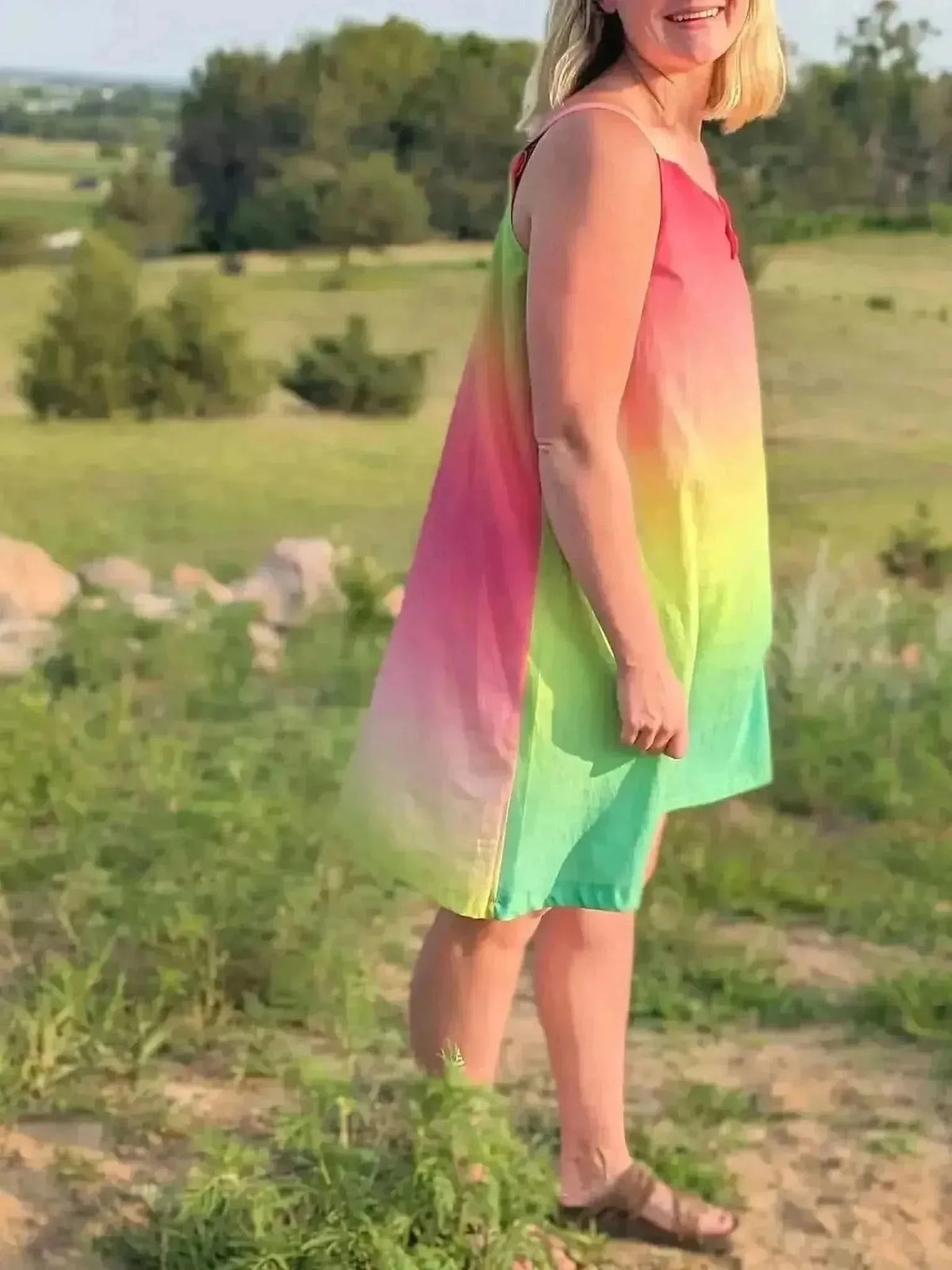 Watermelon ombre gradient fabric with pink-to-green hues on a grassy field.