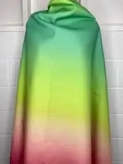 Fabric draped to show a watermelon ombre from green to yellow to pink.